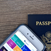 Passport and iPhone with expedia app