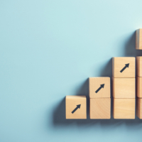Hand arranging wood block stacking as step stair on paper pink background. Business concept growth success process, copy space.