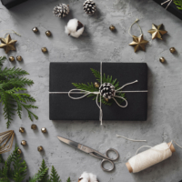 Christmas presents wrapped in black paper