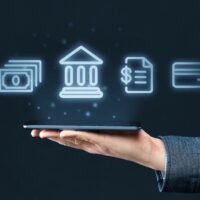 Mobile banking concept. Hand holds smartphone with abstract icons of bank and financial services